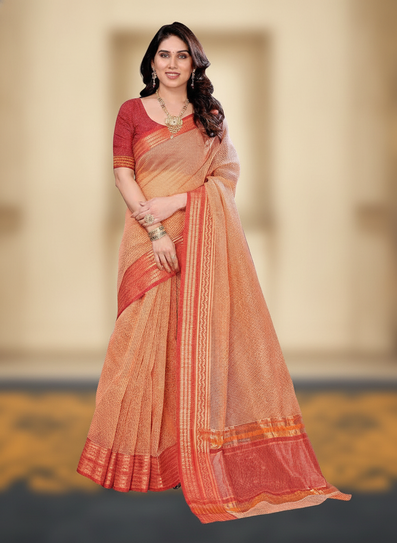 Woman in a peach Kota Doria Cotton Checks Saree with a jacquard border, standing gracefully against a soft, blurred backgroun